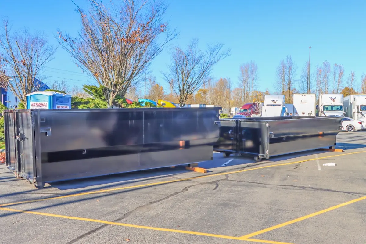 Professional dumpster rental service with roll-off container on residential driveway in Harpswell